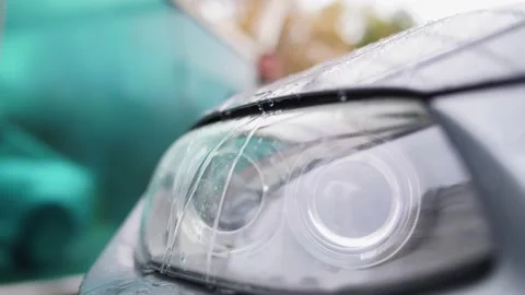 Close-up of an auto headlight.Head light of BMW E92 with raindrops on close up Vidéo 164947840