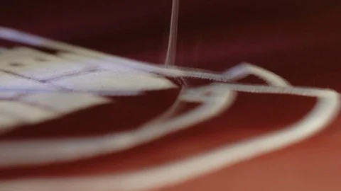 Close up on Automated Machine Embroidering red fabric.Industrial Sewing Stock Footage 116417167