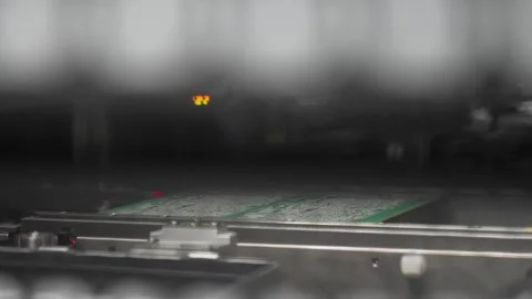 Close up of automated solder paste screen printing process on PCB board inside Stock Footage 334701591