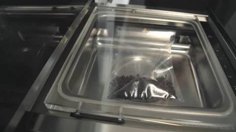 Close up of automated vacuum seal machine packing coffee beans in plastic bag Stock Footage 138200497