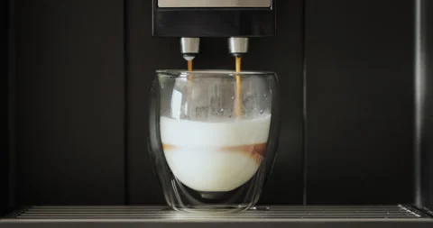 Close up of automatic coffee machine pours coffee into mug at home. Hot coffee Stock Footage 252755860