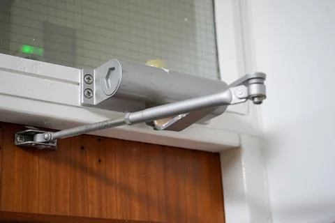 Close up of an automatic door closer 库存照片