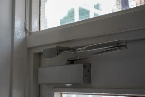 Close up of an automatic door closer 库存照片