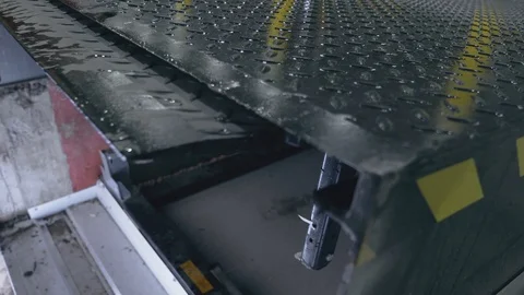 Close-up Automatic loading platform extends in the logistics center Stock Footage 104250906