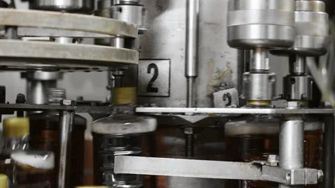 Close-up of automatic screwing of caps on plastic bottles. Stock Footage 288411035