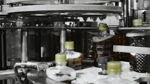 Close-up of automatic screwing of caps on plastic bottles. Stock Footage 288549785