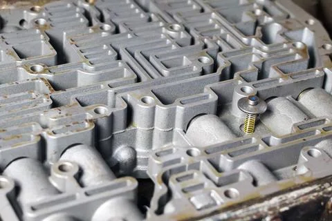 Close-up of automatic transmission valve body with intricate hydraulic chan.. Stock Photos