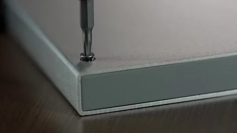 Close-Up of Automatic Unscrewing of a Star-Shaped Screw from a Hard Drive Stock Footage 302799191