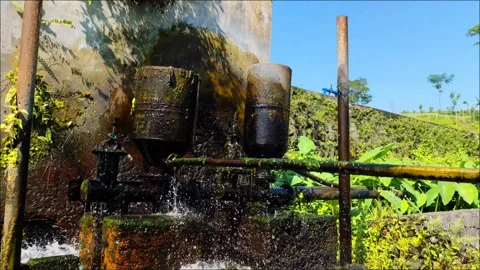 Close-up of automatic water pump without electricity using pressure power Stock Footage 295935577
