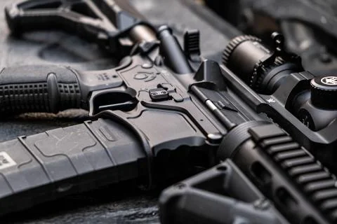 Close up automatic weapon black lying a table Concept of war and private Stock Photos