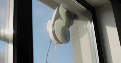 Close up automatic window cleaning robot operating on residential window Stock Footage 320064122