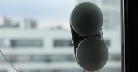 Close up automatic window cleaning robot operating on residential window Stock Footage 320074035