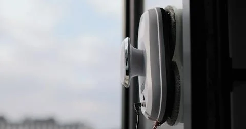 Close up automatic window cleaning robot operating on residential window Stock Photos