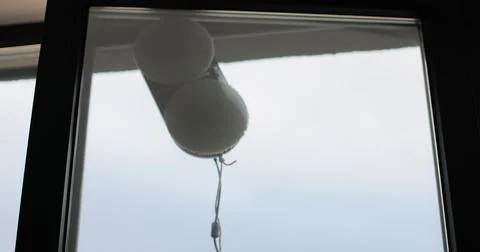 Close up automatic window cleaning robot operating on residential window Stock Photos