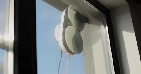 Close up automatic window cleaning robot operating on residential window Stock Photos