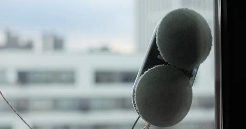 Close up automatic window cleaning robot operating on residential window Stock Photos
