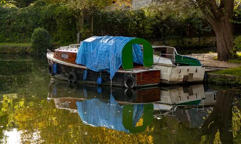 Close up autumn image of two river boats tied to the side of river Yeo in Nor Stock Photos
