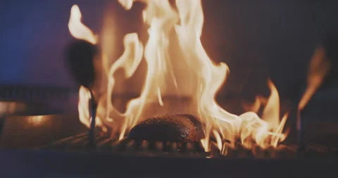 Close up of avokado on grill rack with flames of fire Stock Footage 203556056