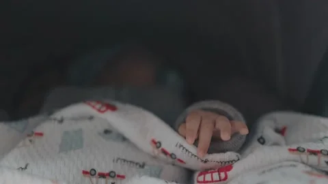 Close up of babies hand while he is sleeping in stroller Stock Footage 191021965