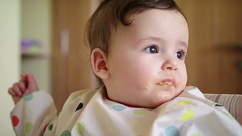 Close up of baby avoiding the feeding spoon Stock Footage 83610460