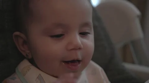 Close Up of Baby Being Spoon Fed in High Chair During Homemade First Foods Stock Footage 337866839