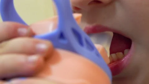 Close-up of a baby drinking from a bottle Stock Footage 235777765