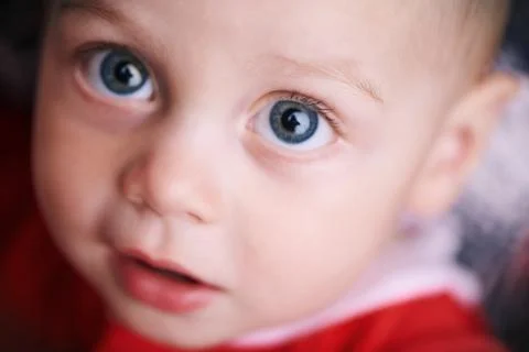 Close up of baby face while looking at the camera Stock Photos