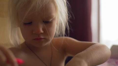 Close up baby girl use felt-tip pens sitting table sunny room rapid slow motion Stock Footage 86594271