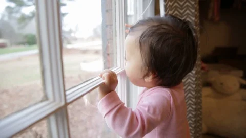 Close Up Baby Looking Outside of Window Stock Footage 93907355