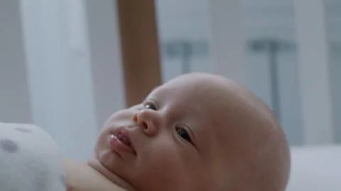 Close up, baby lying in bed, loving mother caressing her newborn baby's head Stock Footage 306045078