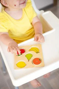 Close-up. Baby is playing. Infant learning and development. Wooden eco-friendly Stock Photos