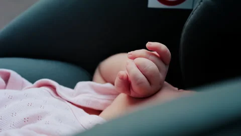 Close up of a baby tiny hands while sitting in a stroller Video stock 316693847