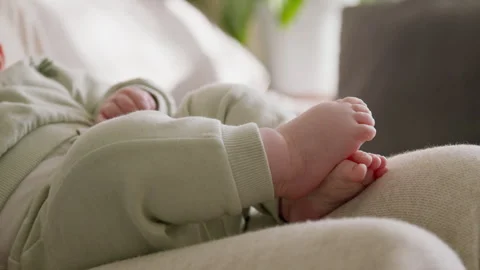 Close-up of a baby's bare feet in the divine morning light. Baby lies in Stock Footage 304697708