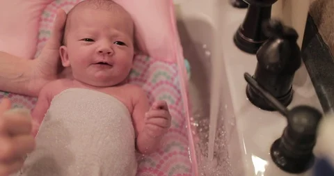 Close Up Baby's First Bath in Slow Motion Stock Footage 104875033