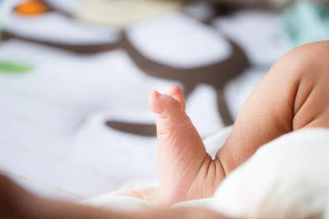 A close up of babys foot resting on soft surface, showcasing tiny toes and de Stock Photos