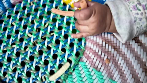 Close Up Of Baby'S Hand Reaching For Veggie Sticks On Colorful Woven Cane Stool 스톡 동영상 328206475