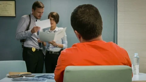 Close up back and neck criminal, detectives to discuss his case and pictures. Video stock 70120998