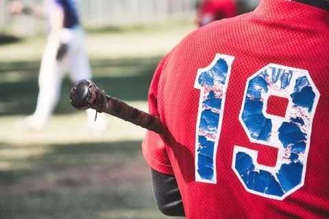 Close-up of the back of a baseball player holding a bat with the number 19 .. Stock Photos