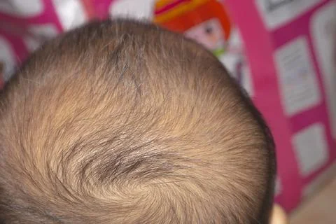 Close up of the back of a black-haired baby's head and no face and copy spa.. Stock Photos