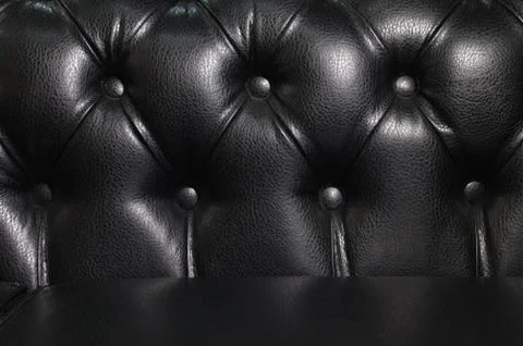 Close-up back of black leather sofa. Luxury Vintage Background Stock Photos