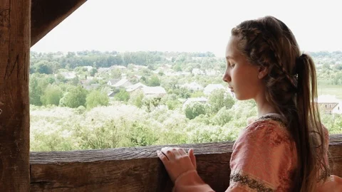 Close up back frame young girl in dress look around in balcony castle beautiful Stock Footage 98251069