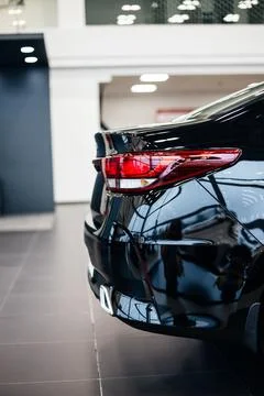 Close up back light of the modern black car. Rear car stop lights on car bumper. Stock Photos