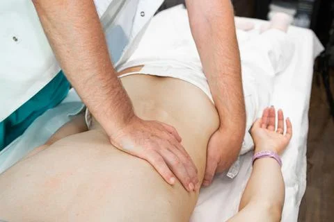 Close up of back massage procedure in spa salon Stock Photos