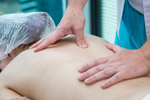 Close up of back massage procedure in spa salon Stock Photos