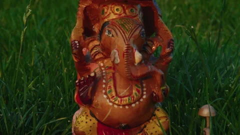 Close-up, back movement, Deity Sri Ganesha Ganapati made of sandalwood stands on Stock Footage 220622618