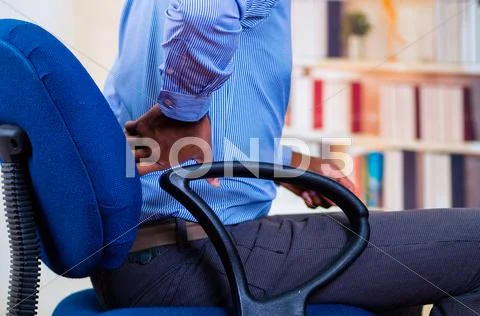 Close up of back pain, man holding his back with one hand Stock Photos