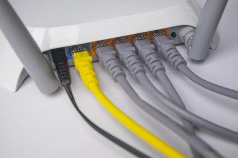 Close-up of the back panel of a white wireless router, fully populated with.. Stock Photos
