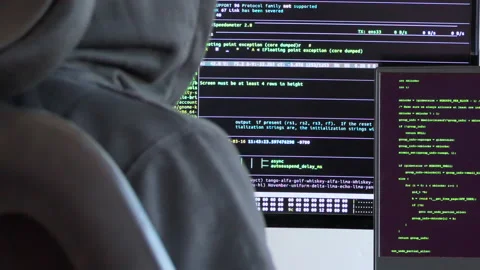 Close back shot of a man waiting for code to execute, hacker sitting on a chair Stock Footage 146607319