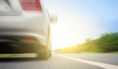 Close up back of  silver car and light on the  road Stock Photos