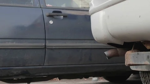 Close up of back of tail pipe of car. The car is started and cloud of smoke Video stock 125209631